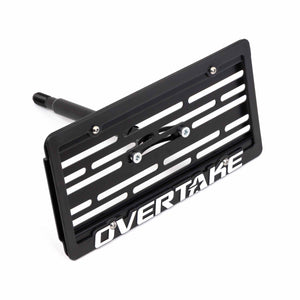 A Subaru license plate relocation kit with the brand name Overtake visible, designed for Subaru vehicles.